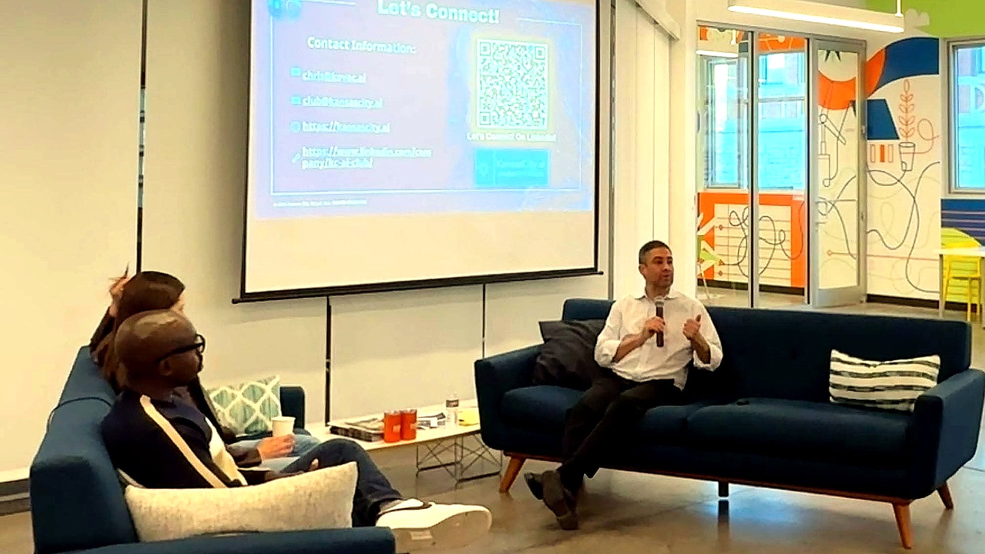 Chris Kovac leading a small-group AI workshop discussion with attendees